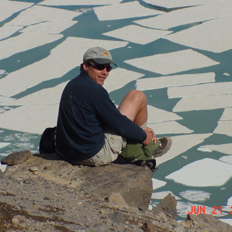 Ned Rozell sits at the edge of the volcanic crater on Mount Katmai during a trip to the Valley of 10,000 Smokes in 2001. Photo by John Eichelberger.